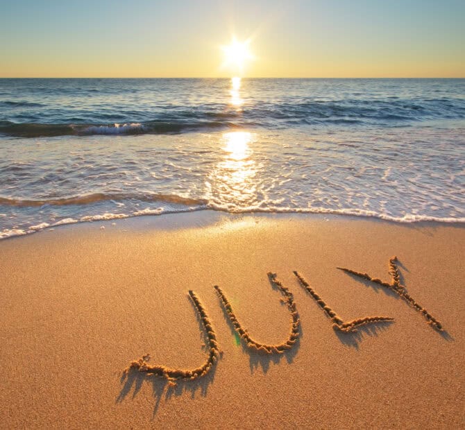 the word July written in the sand on the beach