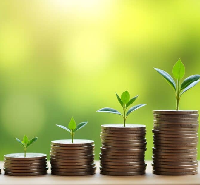 stack of coins with plants growing out of top of them