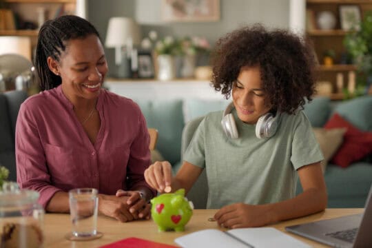 mother and teenager with piggy bank
