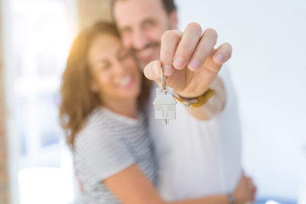 couple holding a house key