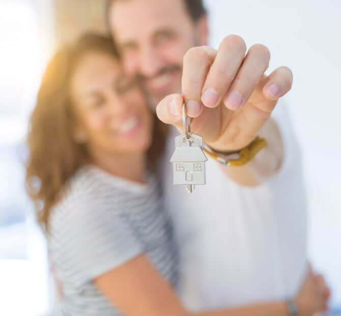 couple holding a house key