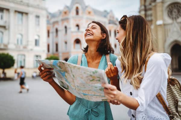 two women on vacation looking at map